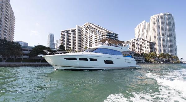 Prestige 550 Fly Prestige 550 Fly yacht cruising near city skyline, 2014 model.