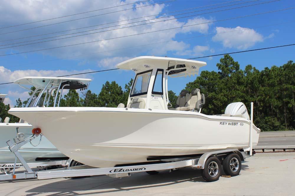 Key West 239 FS 2026 Key West 239 FS boat on trailer, parked outdoors under blue sky.