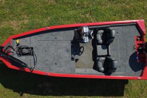 Tracker Pro Team 190 2026 Tracker Pro Team 190 boat, aerial view, red exterior, dual seats, grassy background.