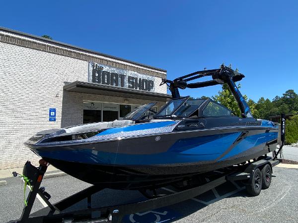 Centurion Ri245 2025 Centurion Ri245 boat on trailer outside a boat shop.