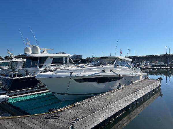 Pursuit OS 405 Offshore 2024 Pursuit OS 405 Offshore yacht docked at marina under clear blue sky.