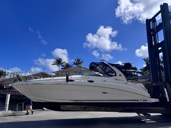 Sea Ray 280 Sundancer 2005 Sea Ray 280 Sundancer boat lifted by forklift under clear blue sky.