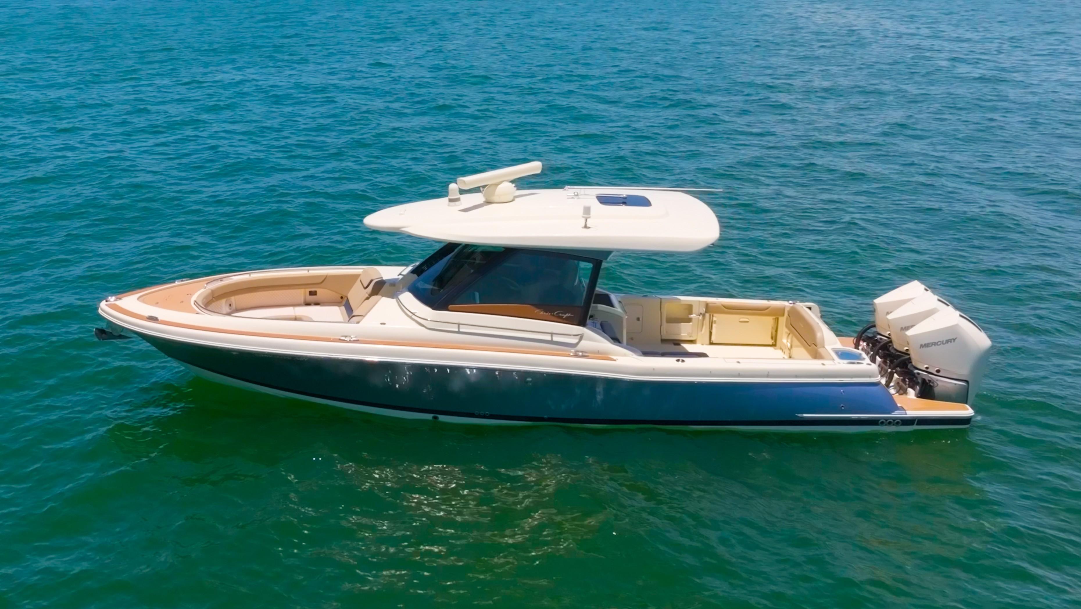 Chris-Craft Calypso 35 2022 Chris-Craft Calypso 35 boat on open water, featuring sleek design and dual outboard engines.