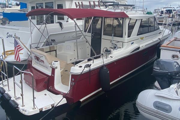 Cutwater C-28 2015 Cutwater C-28 boat docked with red canopy and American flag.