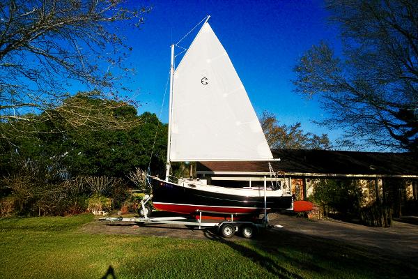 Com-Pac Horizon Day Cat 2014 Com-Pac Horizon Day Cat sailboat on trailer in sunny yard.