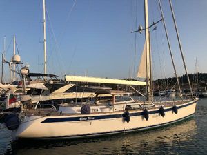 Hallberg-Rassy 64 2018 Hallberg-Rassy 64 sailboat docked in marina at sunset.