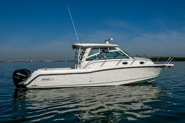 Boston Whaler 345 Conquest 2017 Boston Whaler 345 Conquest boat on calm water under clear blue sky.