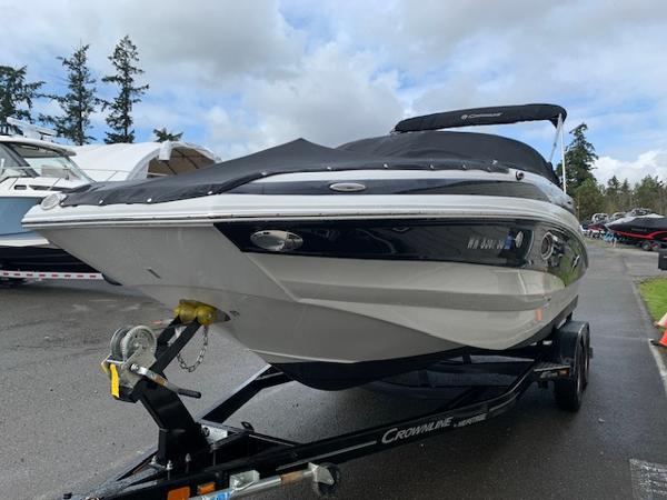 Crownline 235 SS 2020 Crownline 235 SS boat on trailer, parked outdoors under cloudy sky.