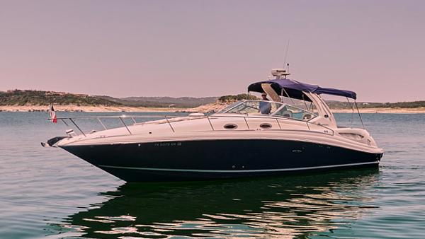 Sea Ray 340 Sundancer 2005 Sea Ray 340 Sundancer boat on calm water with scenic background.