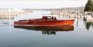 Van Dam 35 Elegant 2015 Van Dam 35 boat on calm water near docks.