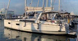 Beneteau Oceanis 38.1 2017 Beneteau Oceanis 38.1 sailboat docked in a marina, reflecting on calm water.