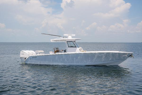 Jupiter 34 LS 340LS 340 LS 2024 Jupiter 34 LS boat on calm ocean waters under a cloudy sky.