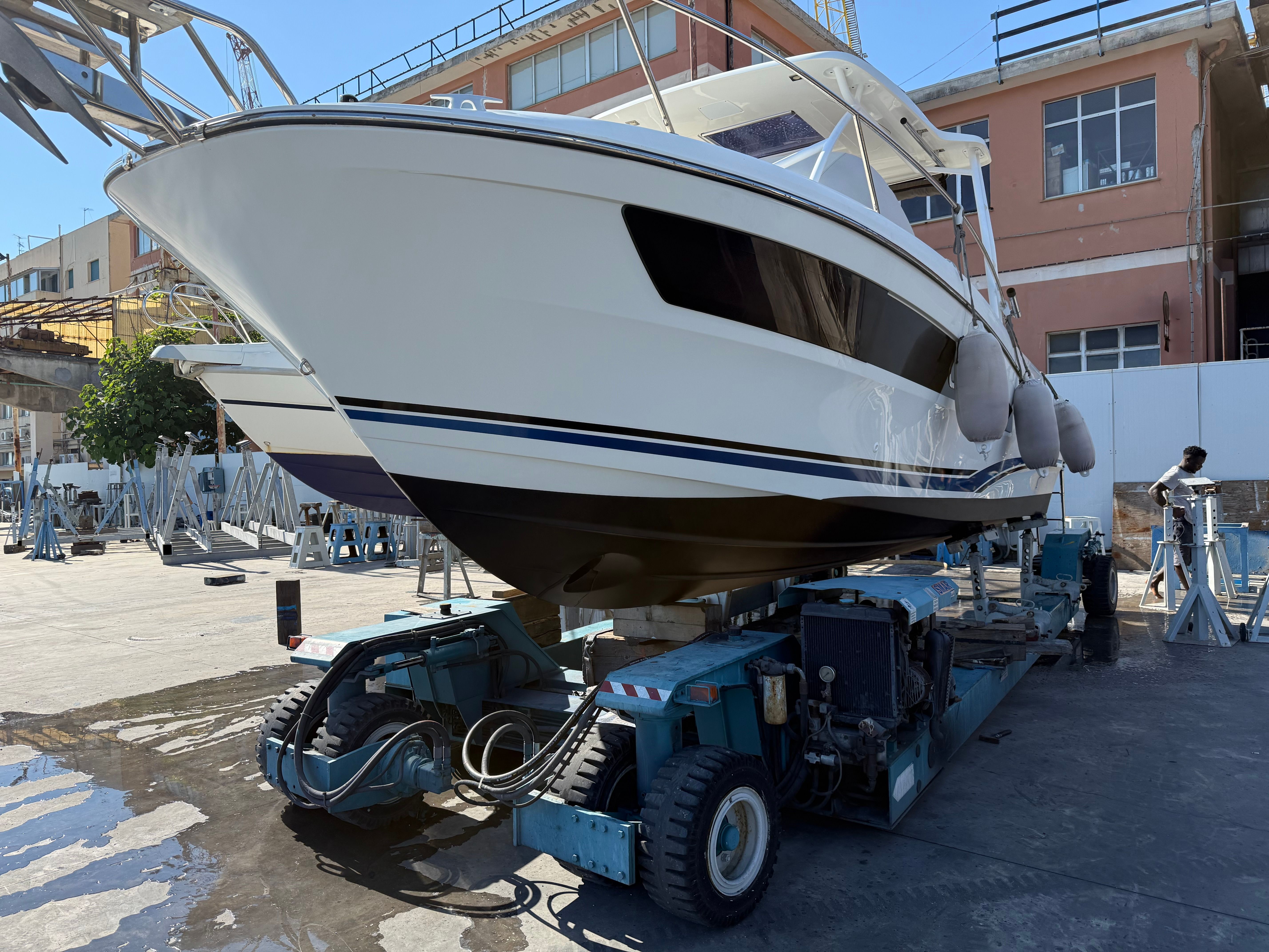Jeanneau Cap Camarat 9 WA 2020 Jeanneau Cap Camarat 9 WA boat on a trailer in a shipyard.