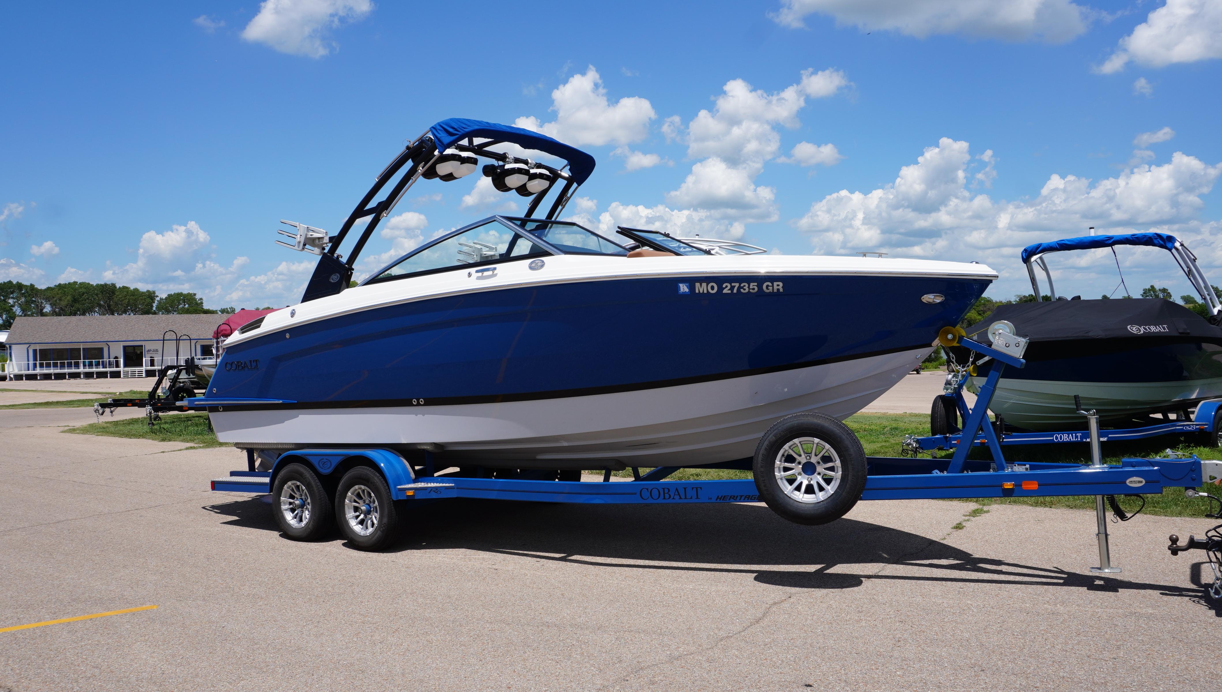 Cobalt R6 2022 Cobalt R6 boat on trailer under blue sky with clouds.