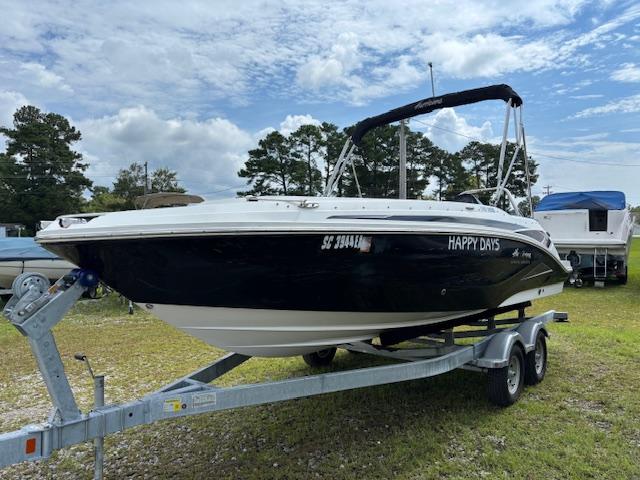 Hurricane SS 205 OB 2022 Hurricane SS 205 OB boat on trailer, named "Happy Days," under a partly cloudy sky.