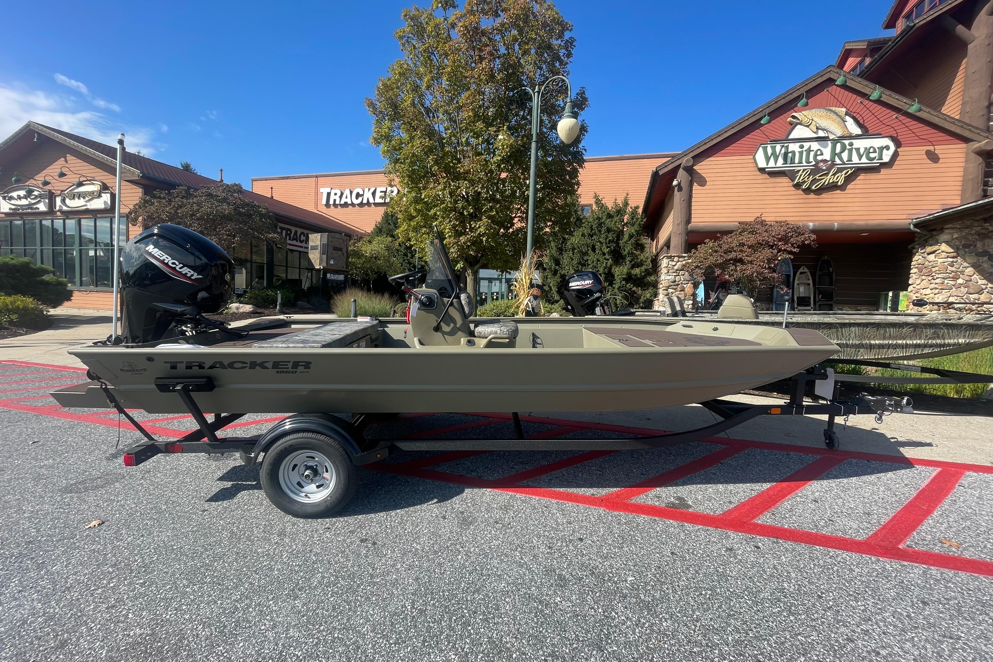 Tracker Grizzly 1860 CC 2026 Tracker Grizzly 1860 CC boat on trailer outside White River Fly Shop.