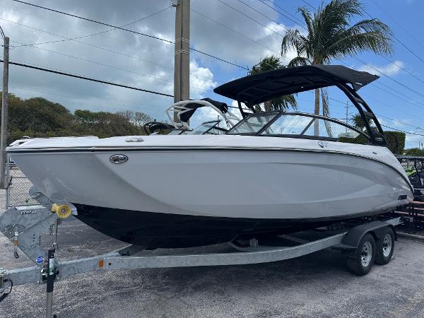 Yamaha Boats 252SD 2025 Yamaha Boats 252SD on trailer, sleek design, palm trees in background.