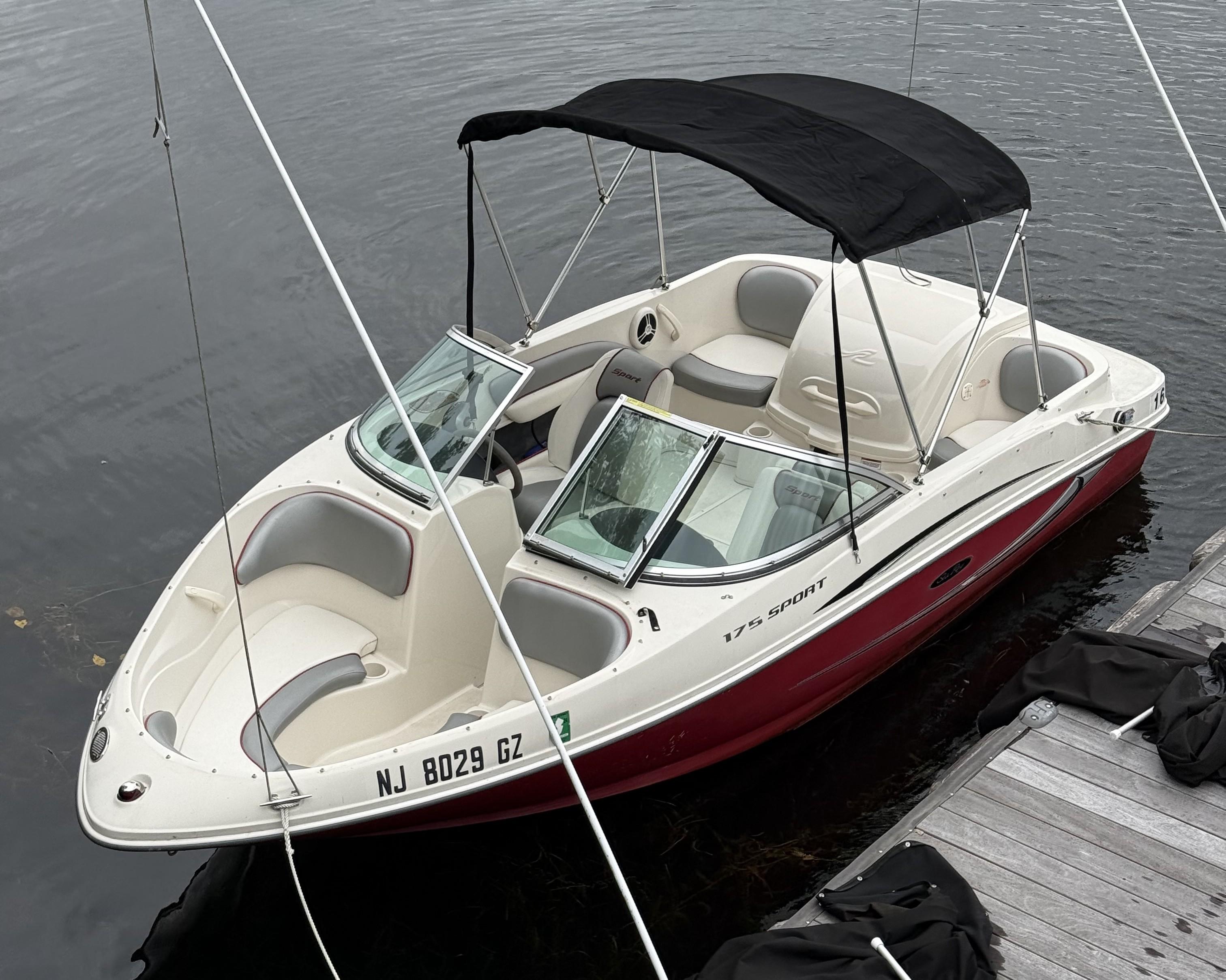 Sea Ray 175 Sport 2008 Sea Ray 175 Sport boat docked, featuring a sleek design and black canopy.