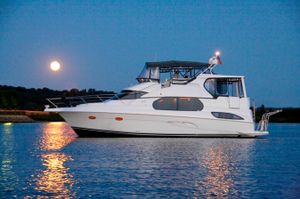 Silverton 43 Motor Yacht 2002 Silverton 43 MY yacht on calm water at dusk with full moon.