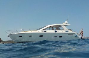 Sealine SC47 2012 Sealine SC 47 yacht cruising on open water under clear blue sky.