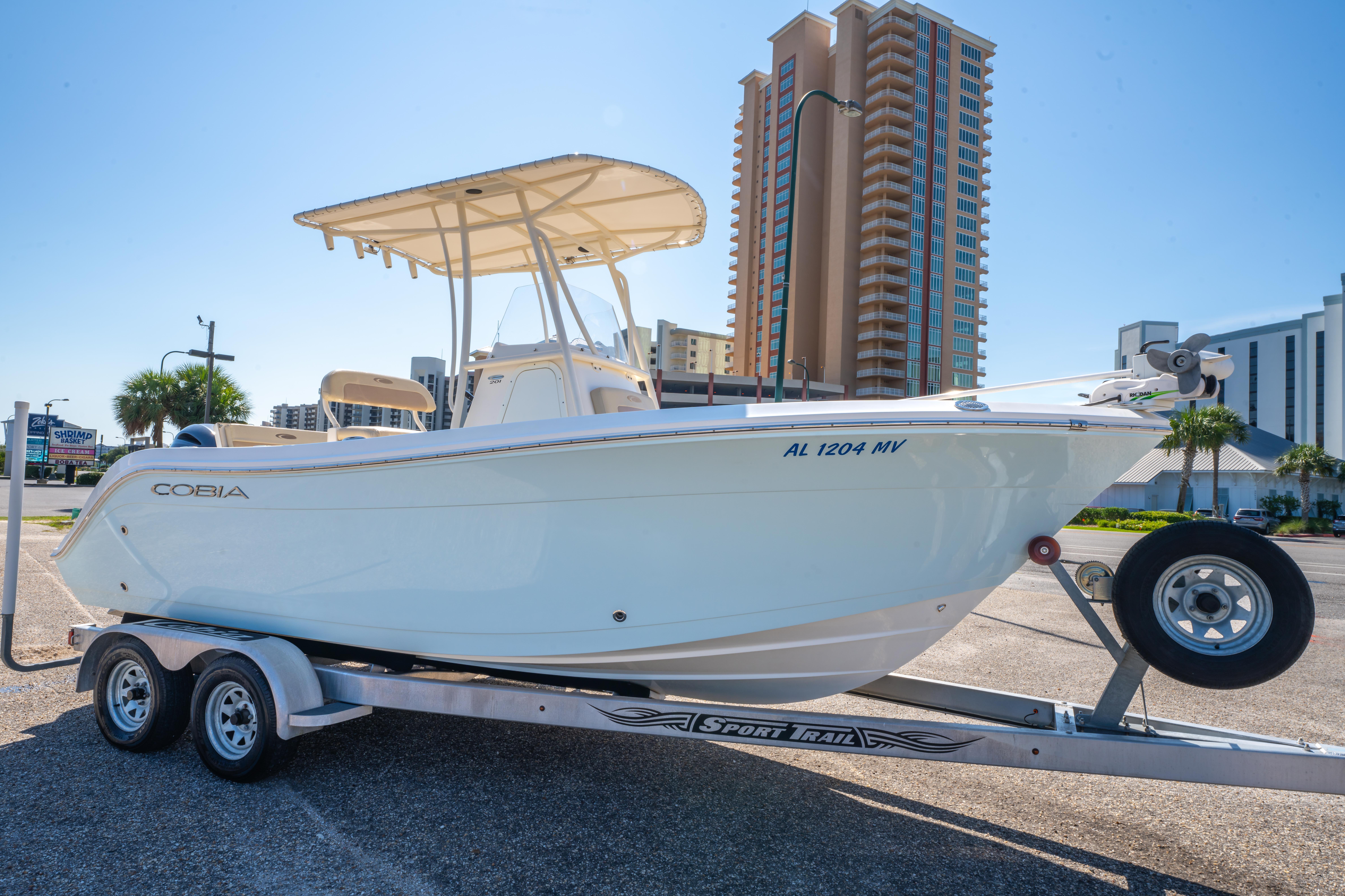 Cobia 201 Center Console 2016 Cobia 201 Center Console boat on trailer, urban background with tall buildings.