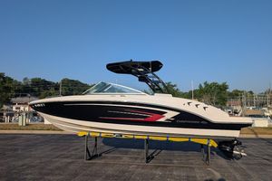 Chaparral 23 SSi 2023 Chaparral 23 SSi boat on display, black and white design, outdoor setting.