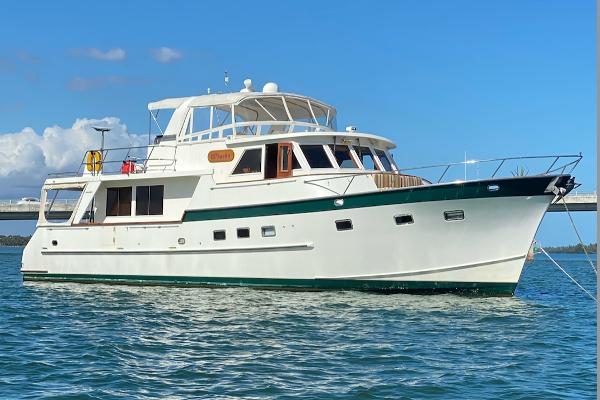 Grand Alaskan 60 Pilothouse Grand Alaskan 60 Pilothouse yacht, 1998 model, anchored on calm blue waters.
