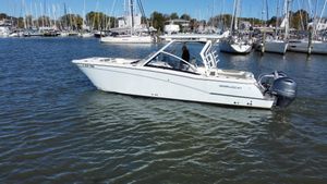 World Cat 280 DC x 2020 World Cat 280 DC x boat cruising in a marina with sailboats in the background.