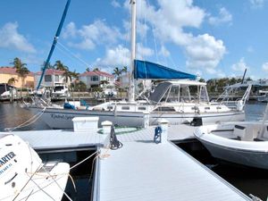 Morgan 43 CC 1987 Morgan 43 CC sailboat docked at marina under blue sky.