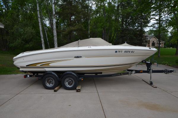 Sea Ray 210 Bow Rider 2001 Sea Ray 210 Bow Rider boat on a trailer in a driveway.