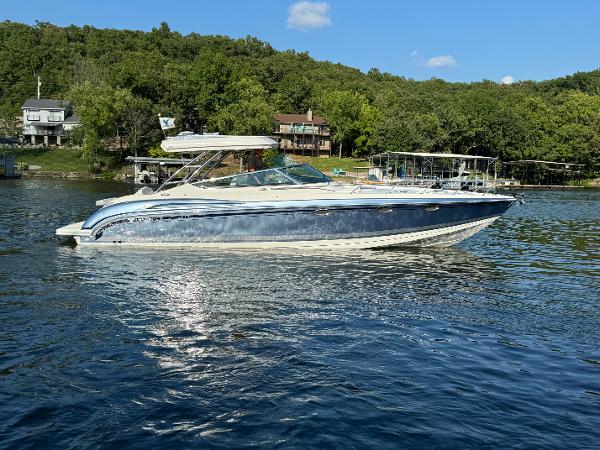 Formula 370 Ss 2020 Formula 370 SS boat on a serene lake with lush green surroundings.