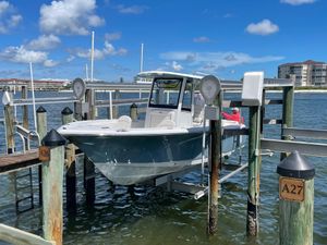 Sea Hunt Ultra 265 SE 2021 Sea Hunt Ultra 265 SE boat docked at marina under clear blue sky.