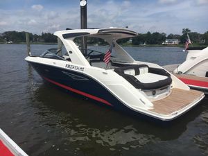 Sea Ray 310 SLX 2017 Sea Ray 310 SLX boat docked on a calm lake with American flags.