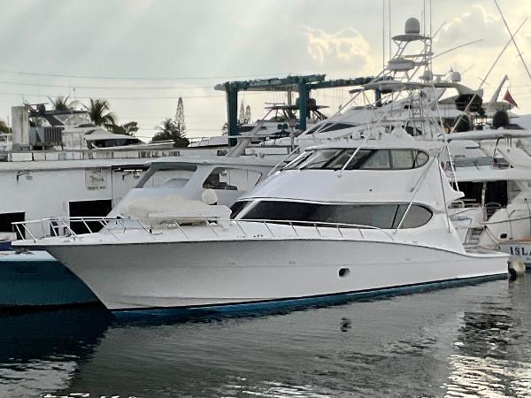 Hatteras 77 Convertible 2008 Hatteras 77 Convertible yacht docked at marina, sleek white design.