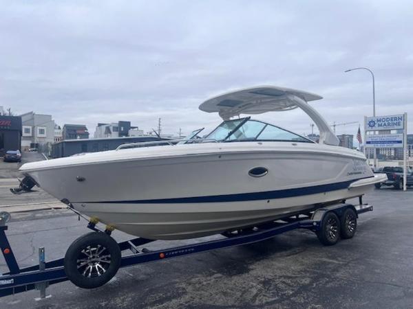 Chaparral 307 SSX 2021 Chaparral 307 SSX boat on trailer, displayed outdoors at a marina.