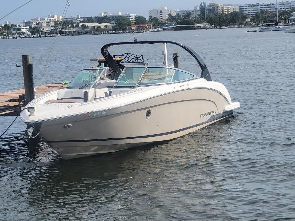 Regal 3200 Bowrider 2017 Regal 3200 Bowrider boat docked on a calm waterfront.
