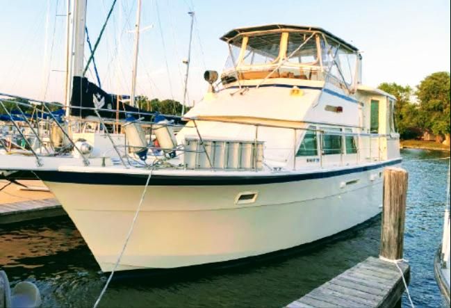 Hatteras 43 Motor Yacht 1986 Hatteras 43 Motor Yacht docked at marina, side view.