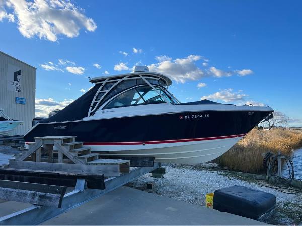 Pursuit DC 265 Dual Console 2014 Pursuit DC 265 Dual Console boat on a trailer, under a blue sky.