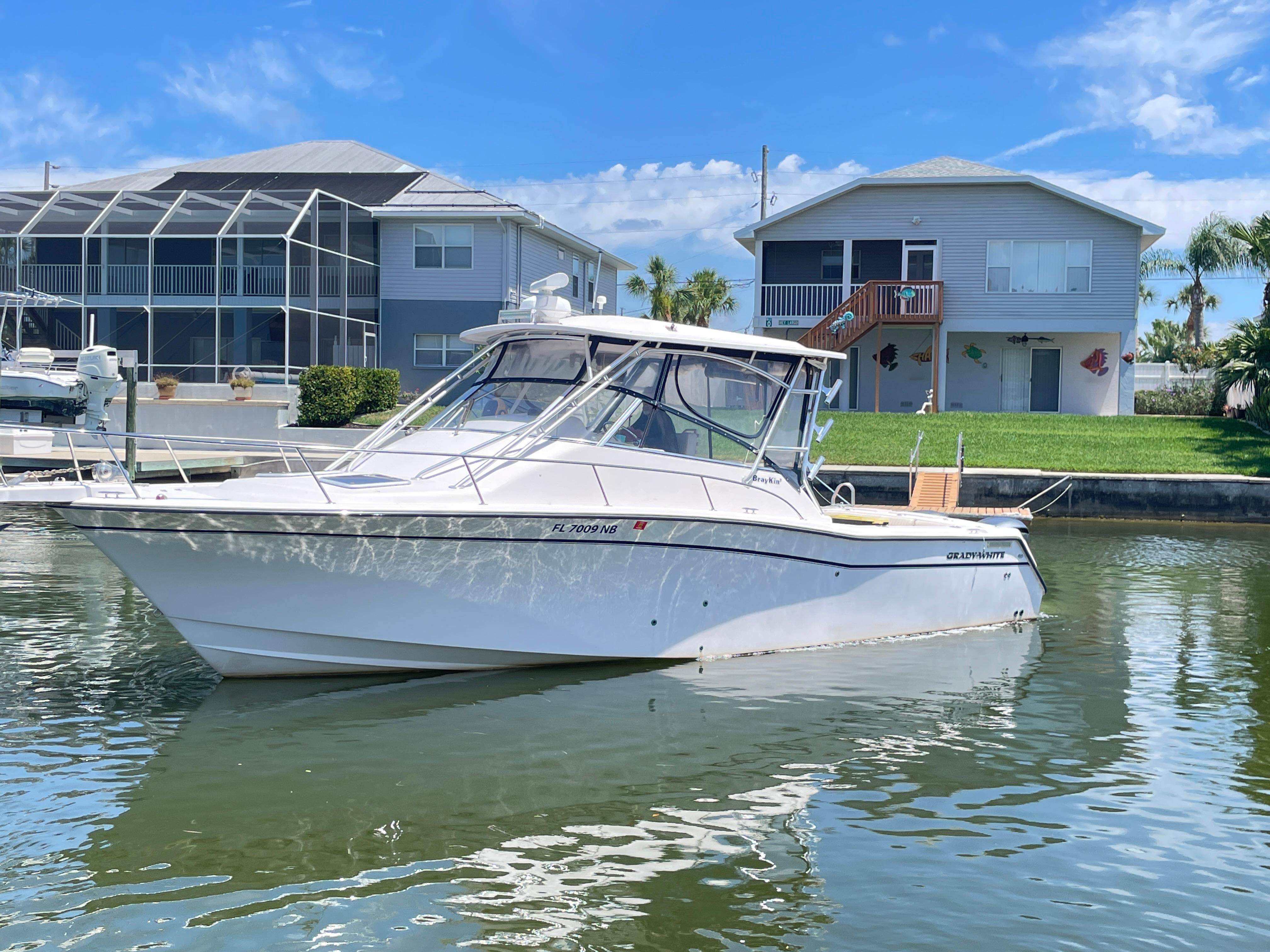 Grady-White Express 330 2005 Grady-White 330 Express boat docked near waterfront homes.