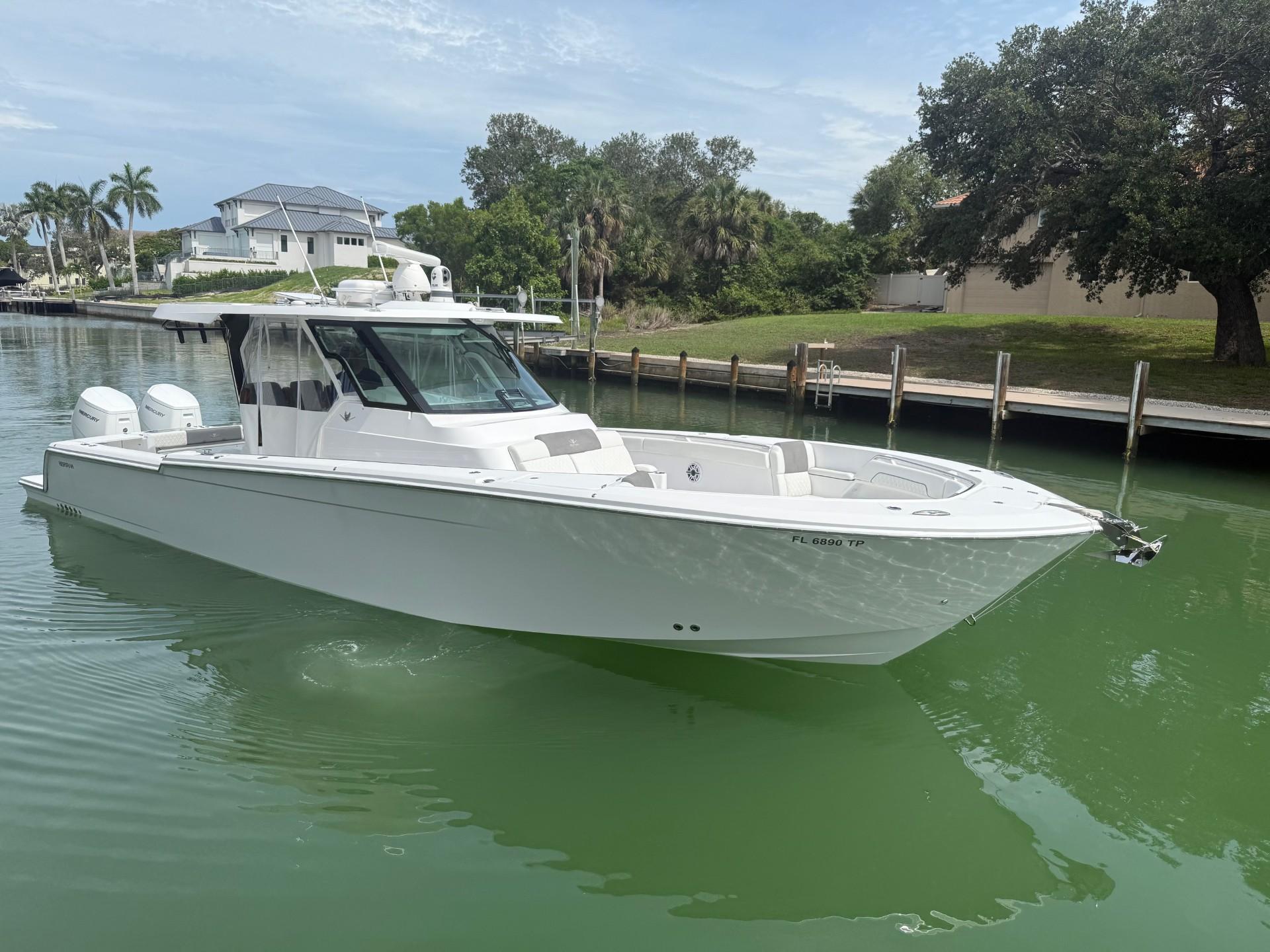 Bertram 39 CC 2023 Bertram 39 CC boat on calm water, surrounded by lush greenery and waterfront homes.