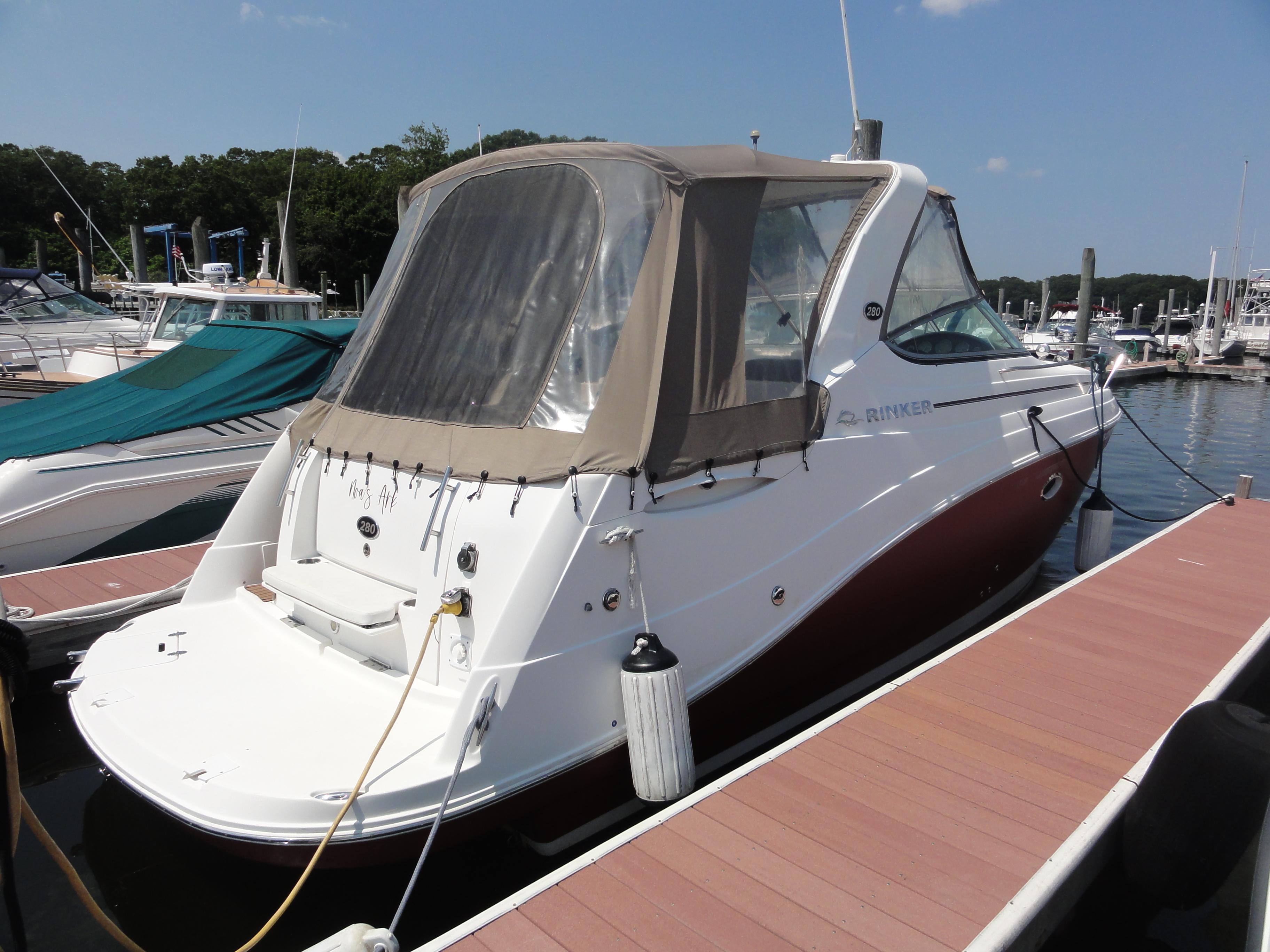 Rinker 280 Express Cruiser 2008 Rinker 280 Express Cruiser docked at marina under clear sky.