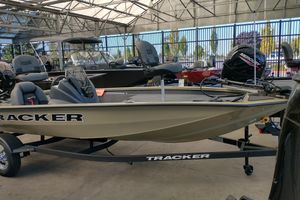 Tracker Pro Team 175 2026 Tracker Pro Team 175 boat displayed in a showroom with other boats.