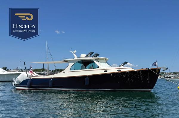 Hinckley 35 2024 Hinckley 35 yacht on water, certified pre-owned, clear blue sky background.