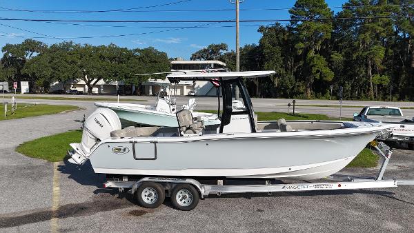 Sea Hunt Ultra 245 SE 2025 Sea Hunt Ultra 245 SE boat on trailer in parking lot.