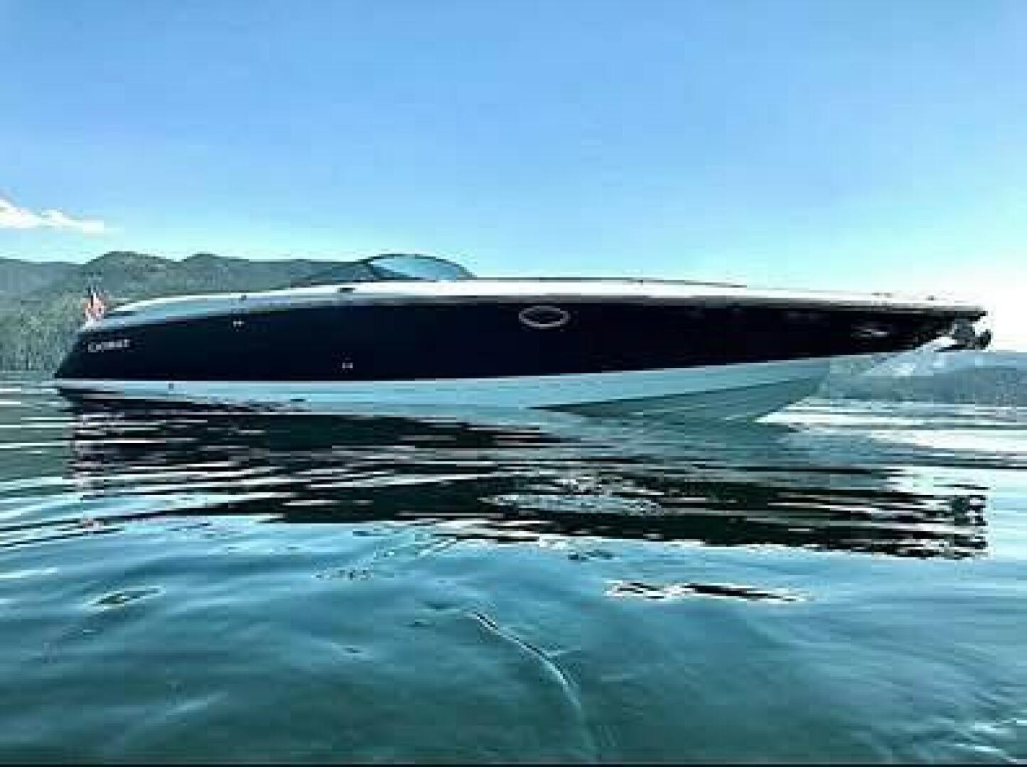Cobalt 343 2005 Cobalt 343 boat on calm water with scenic mountain backdrop.