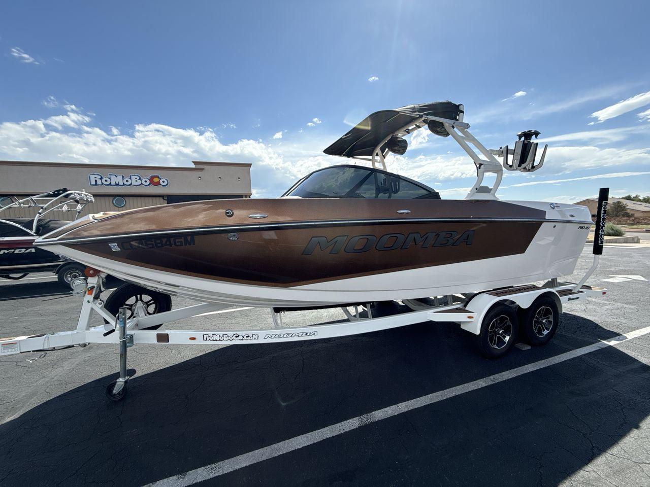 Moomba Mojo 2021 Moomba Mojo boat on trailer under clear blue sky.