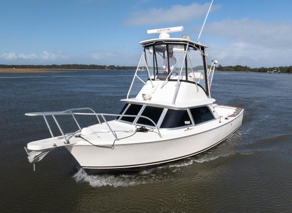 Bertram 31 Sportfisher 1974 Bertram 31 Sportfisher cruising on calm waters under a clear sky.