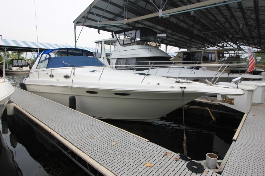 Sea Ray 330 Sundancer 1998 Sea Ray 330 Sundancer docked in a marina under a covered structure.