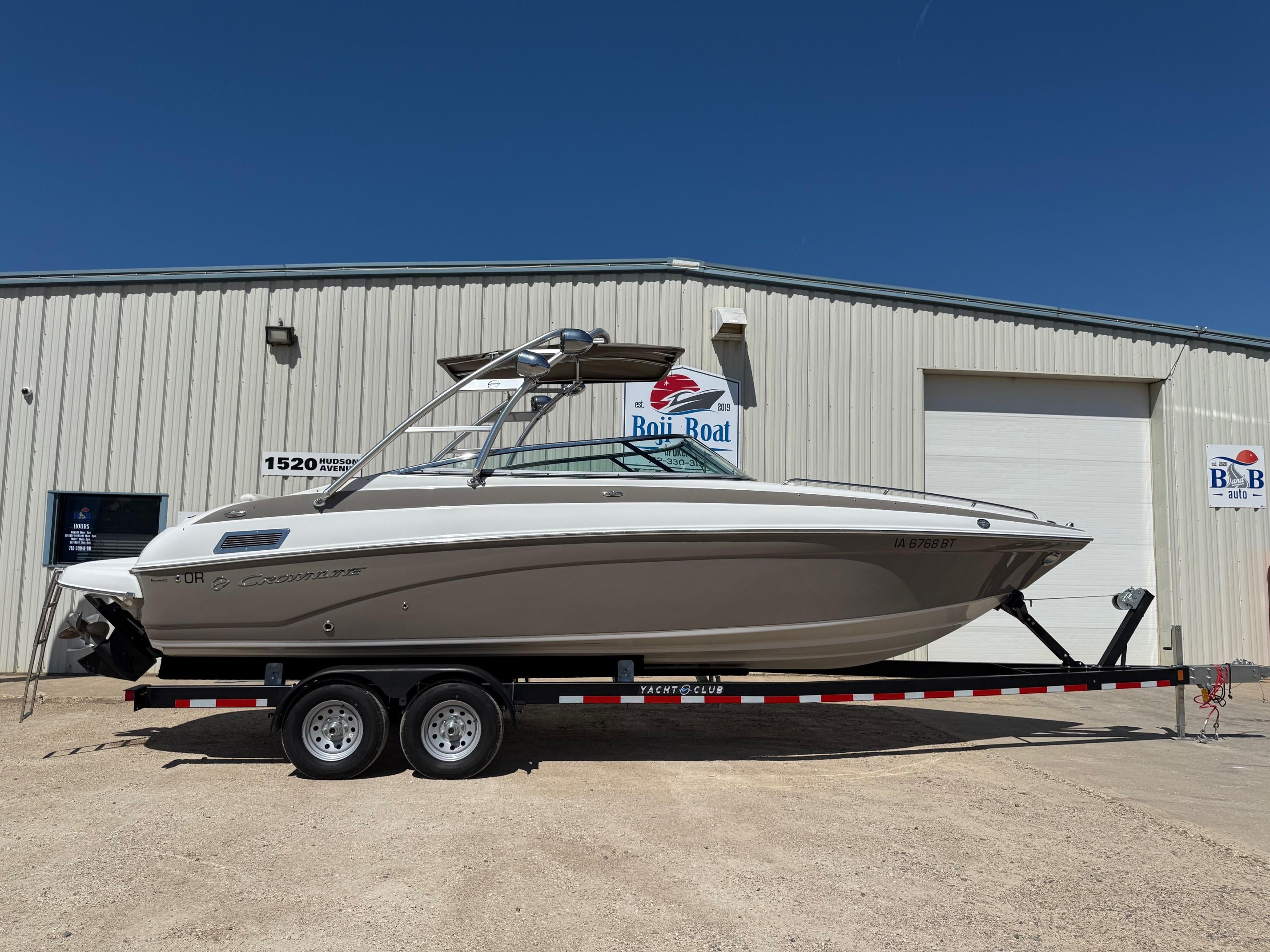 Crownline 270 BR 2009 Crownline 270 BR boat on trailer outside a warehouse.