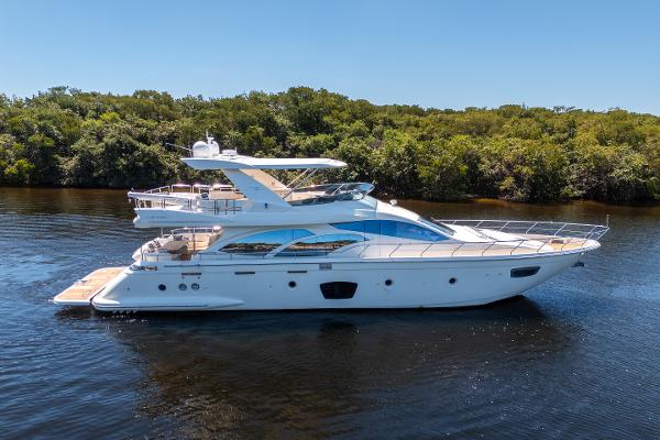 Azimut 75 Azimut 75 Fly 2010 yacht cruising on a calm river with lush greenery.